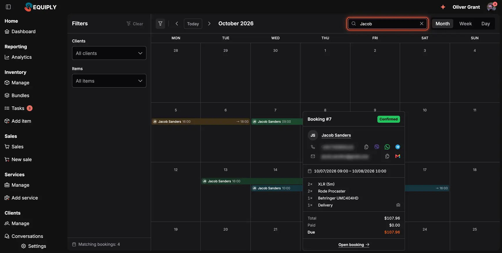 The booking calendar for October 2026 filtered by the search Jacob, with a preview card next to a booking bar showing booking #7, the client Jacob Sanders with contact buttons, dates, items and the total, paid and due